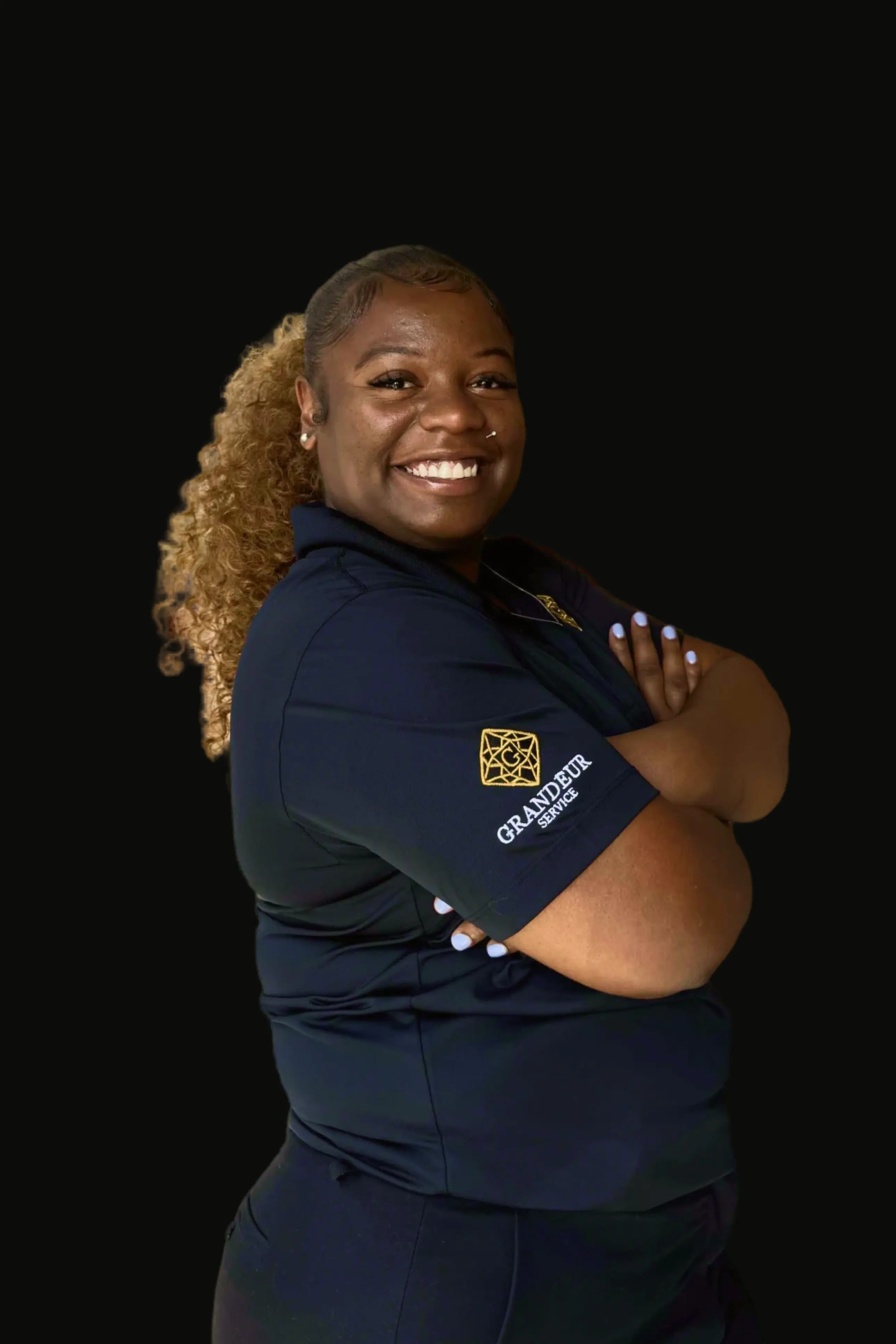 a black woman with long hair, smiling, wearing a nice coat