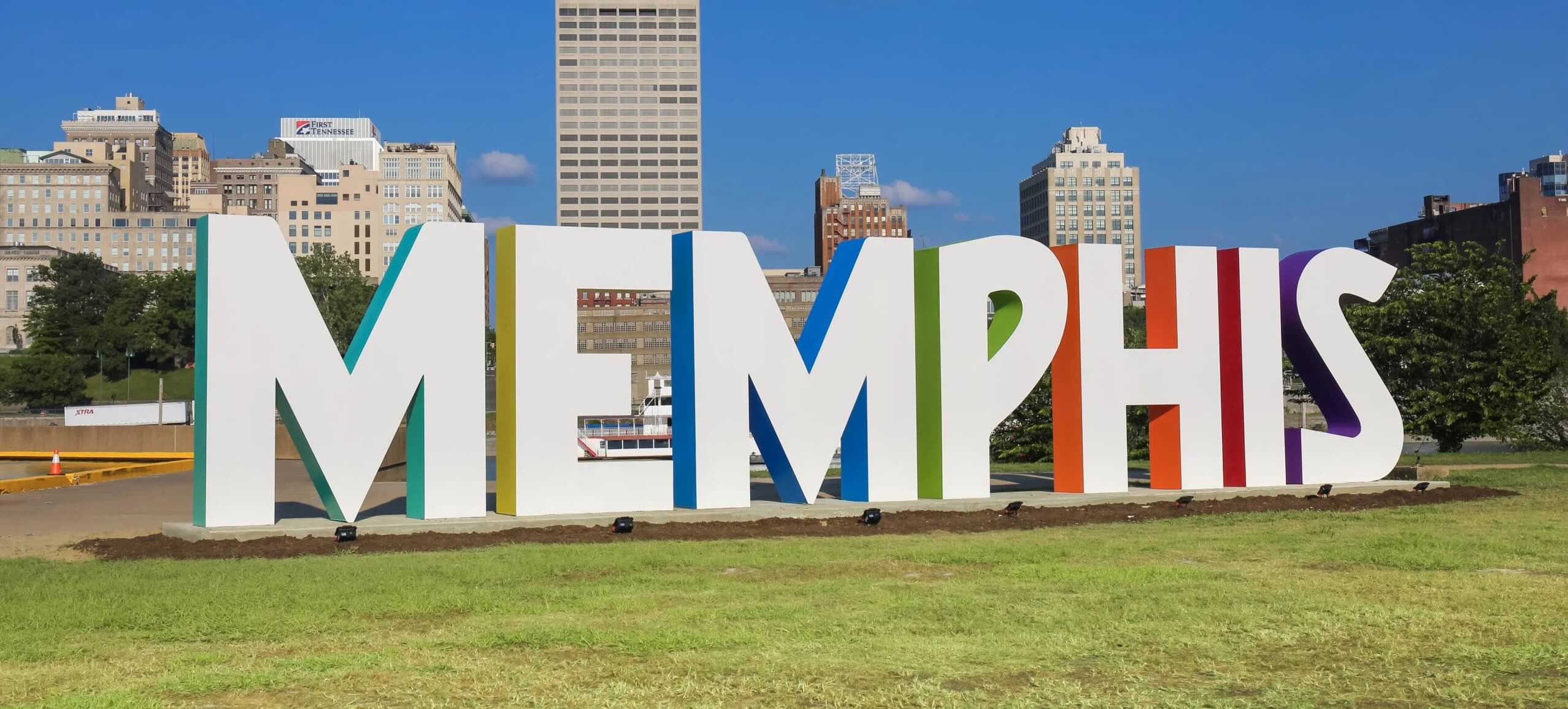 skyline view of memphis, with a large pyramid building and the Herman de Soto Bridge, which stretches across the Mississippi River