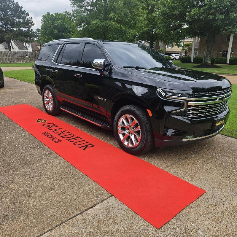 luxury black suv with a red carpet in front of it for luxury event travel in Memphis